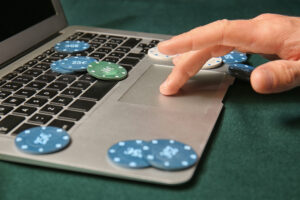 Young man playing poker online, closeup